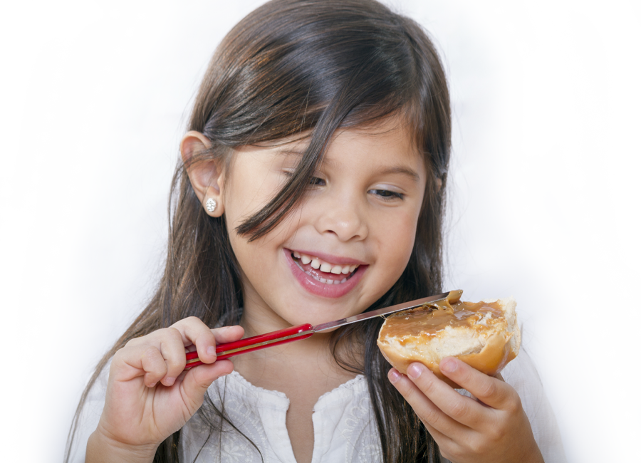 young girl eating peanut butter