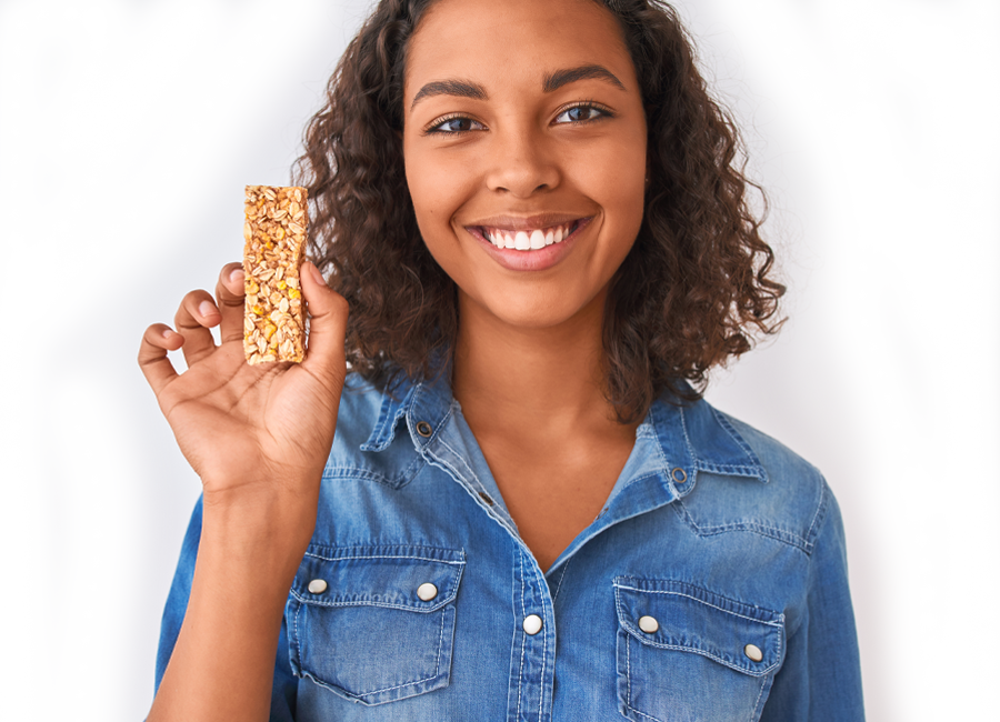 happy woman eating granola bar